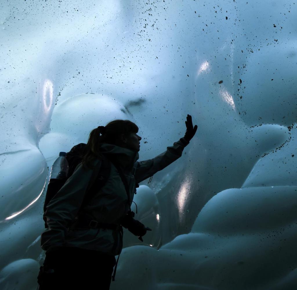 09.26.2019, Switzerland, Betmeralp: Stephanie gropes in an ice cave on the Swiss Aletsch Glacier.  One of the largest glaciers in Europe, the Swiss Aletsch Glacier is the first UNESCO World Heritage Site in the Alps.  This huge glacier, which stretches more than 23 kilometers from its formation in the Jungfrau region (at an altitude of 4000 meters) to the Massa Gorge in Valais, at a depth of about 2500 meters, enchants and delights every visitor.  (to dpa 