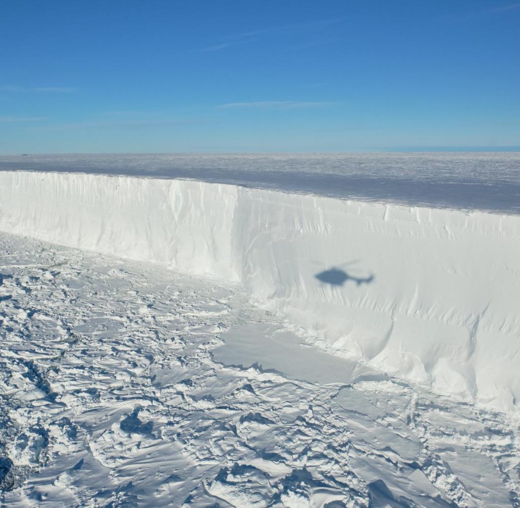 During the helicopter flight along the edge of the newly broken A 74 glacier, the shadow of the helicopter can be seen on the ice (undated flyer).  In February, a giant iceberg broke the ice shelf in Antarctica.  she was 