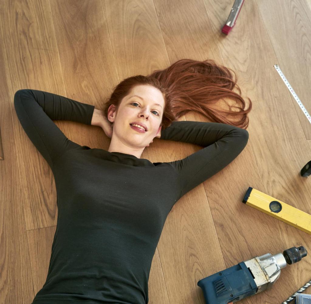 Red-haired woman lying beside tools on the floor