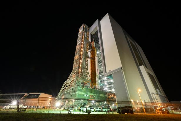 NASA's Next Generation Moon Rocket, the Space Launch System rocket with the Orion crew capsule perched on top, leaves the Vehicle Assembly Building
