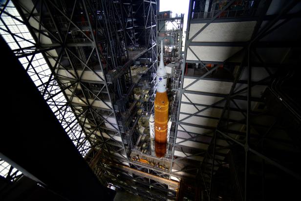 NASA's Next Generation Moon Rocket, the Space Launch System rocket with the Orion crew capsule perched on top, leaves the Vehicle Assembly Building