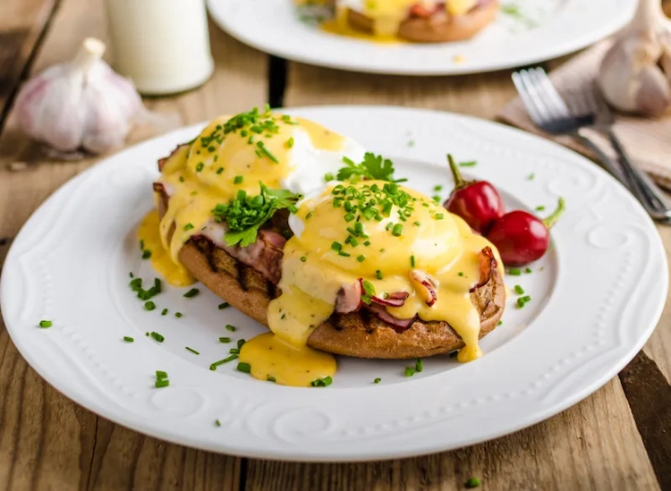 Poached eggs Benedict with hollandaise sauce as a popular breakfast recipe