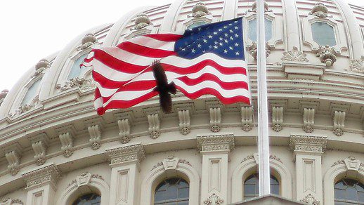 The American flag flies over the US Capitol building in Washington