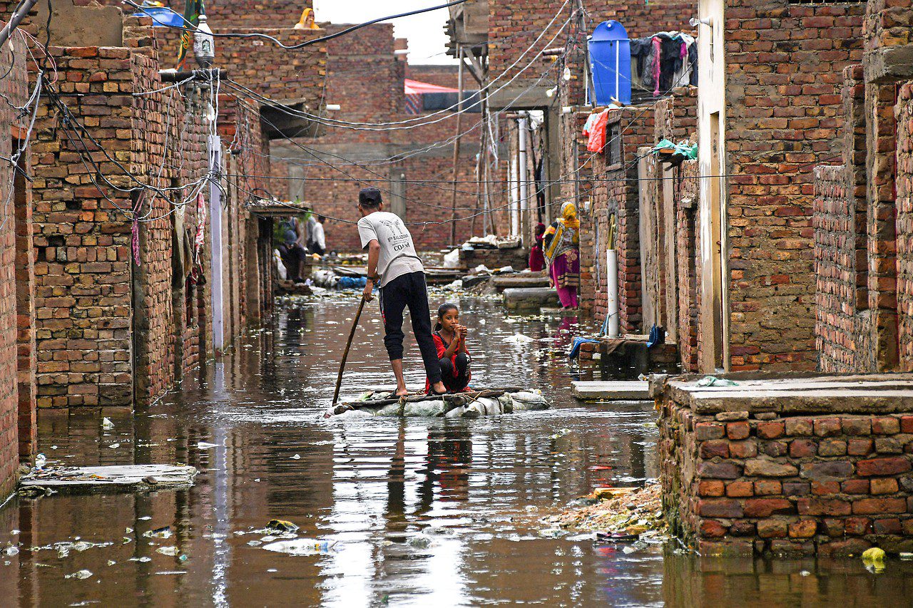 A man and a girl on a flooded street in Hyderabad