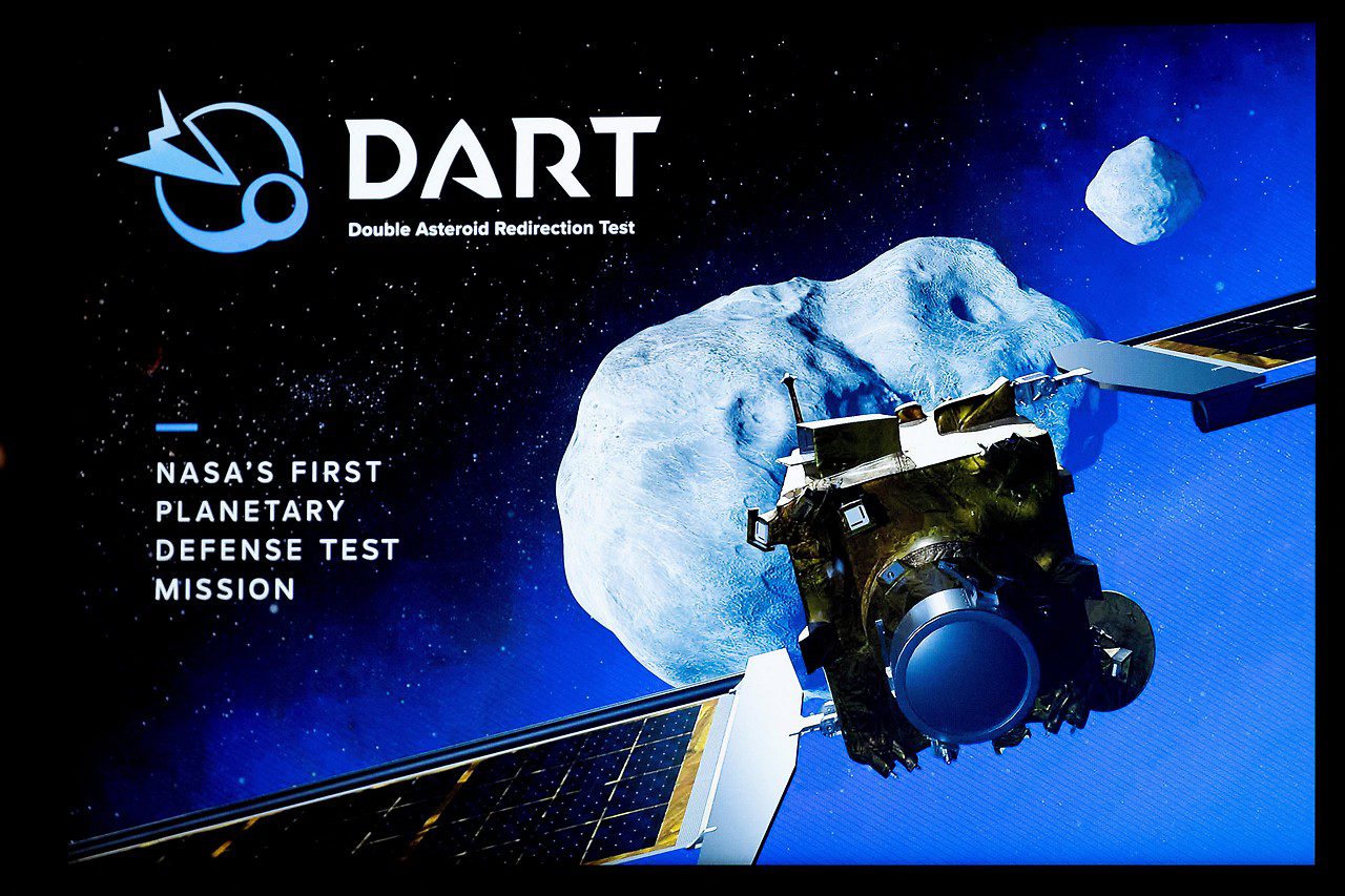 Illustration of the DART spacecraft in front of an asteroid
