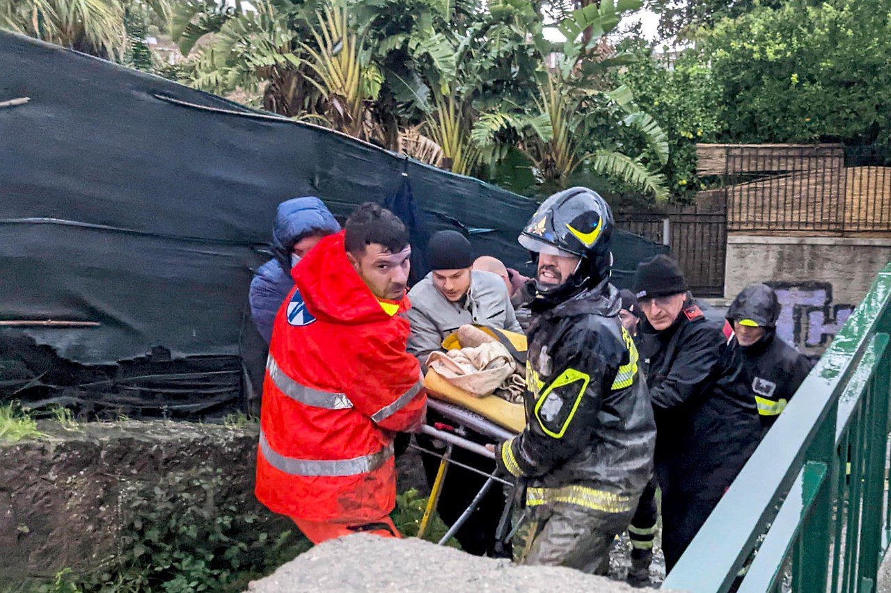 Rescue workers rescue an injured person after a landslide on the Italian island of Ischia